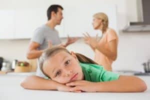 sad child fighting parents